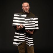 Seth Rogen holding six Sephora shopping bags
