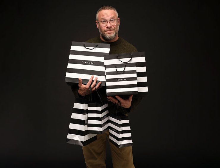 Seth Rogen holding six Sephora shopping bags