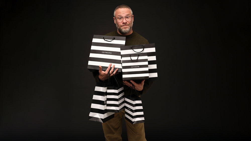 Seth Rogen holding six Sephora shopping bags